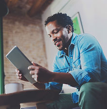 A Man Looking at his Tablet Device