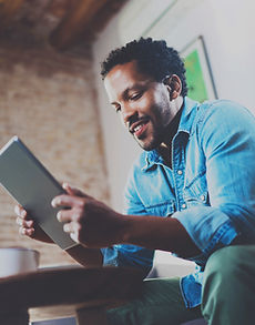 A Man Looking at his Tablet Device