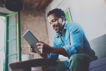 A Man Looking at his Tablet Device