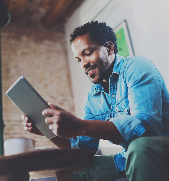A Man Looking at his Tablet Device