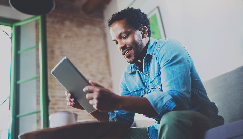 A Man Looking at his Tablet Device