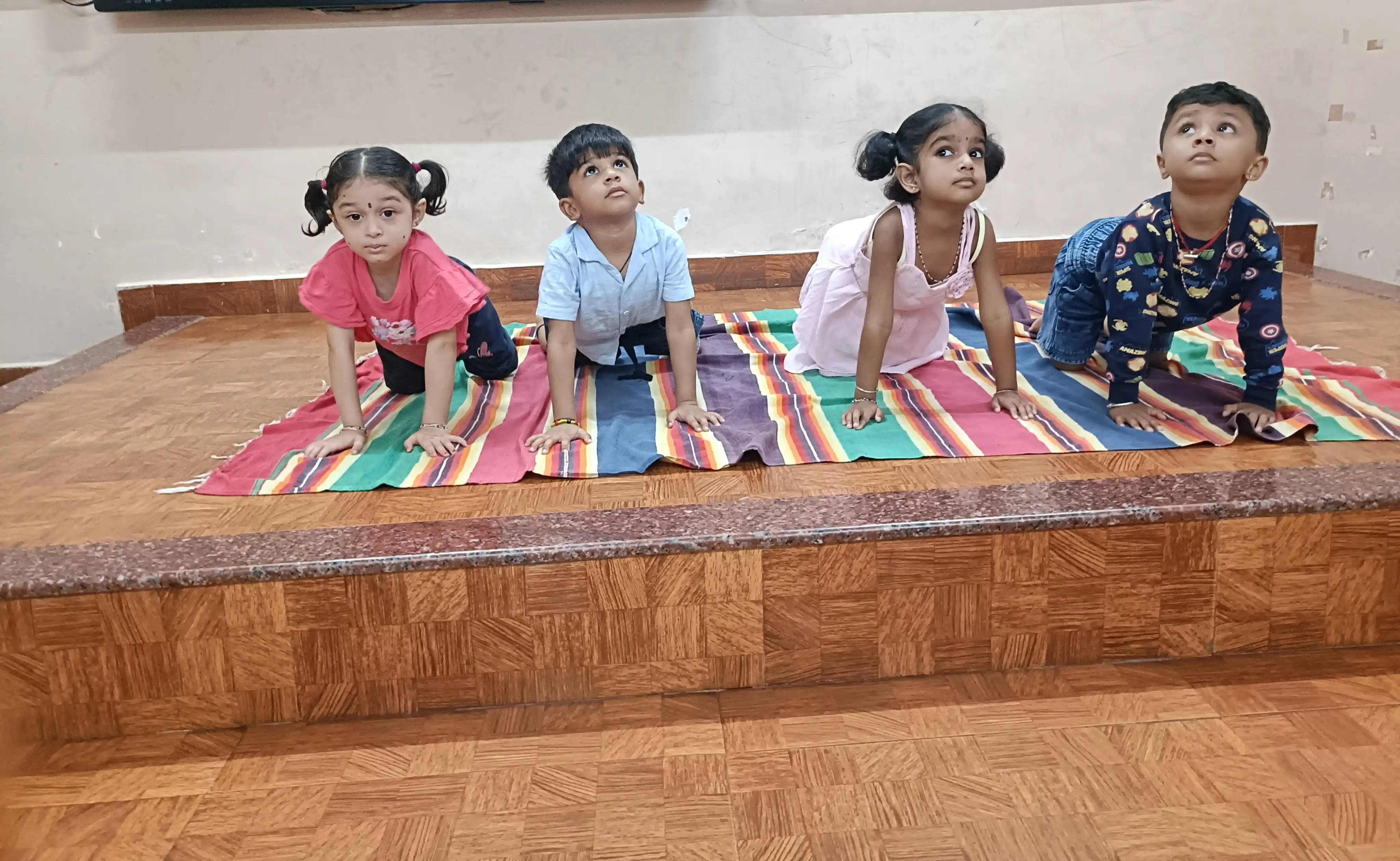 Children practicing yoga postures at Vidyodaya Public School