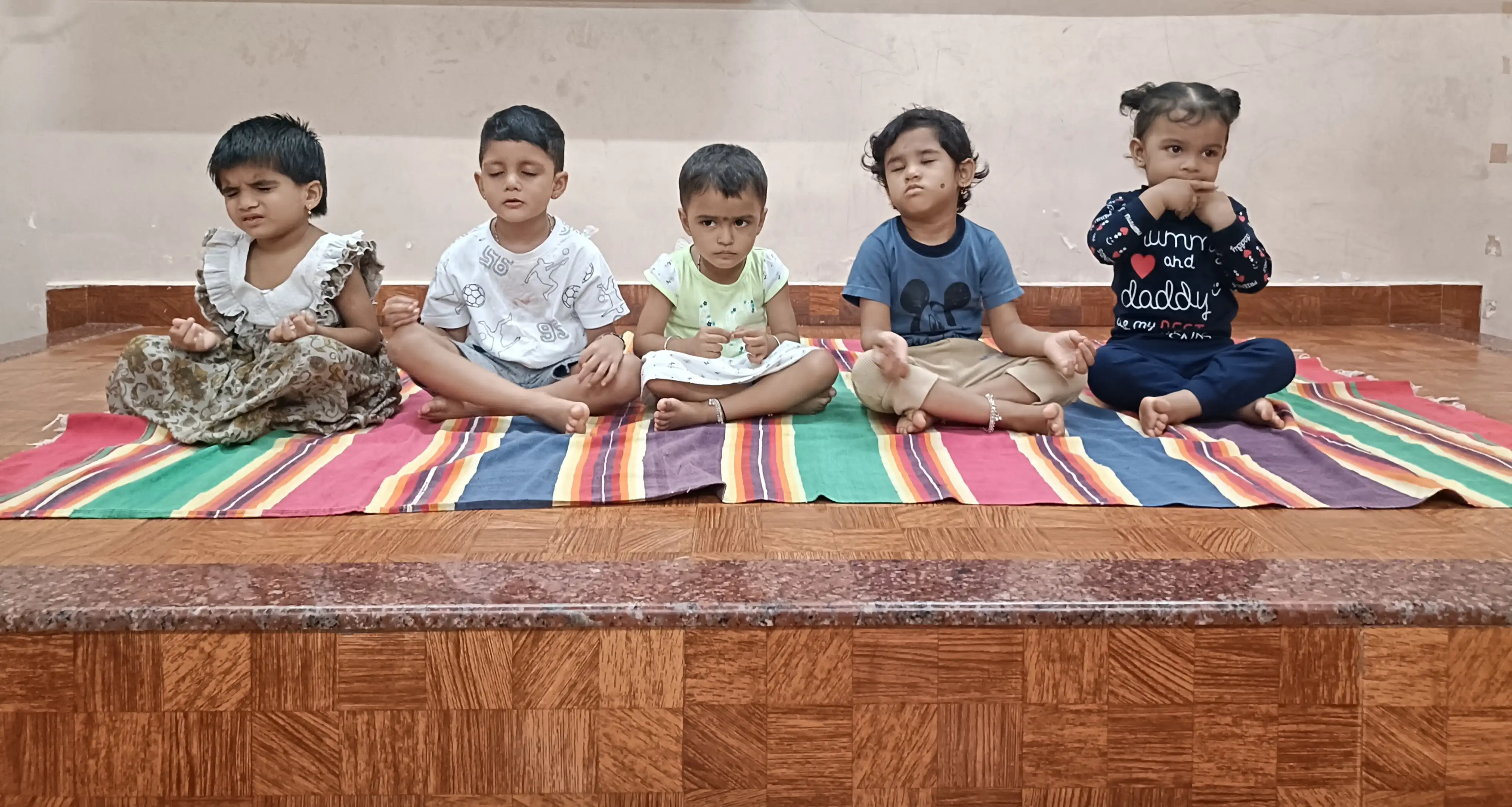 Children practicing yoga postures at Vidyodaya Public School
