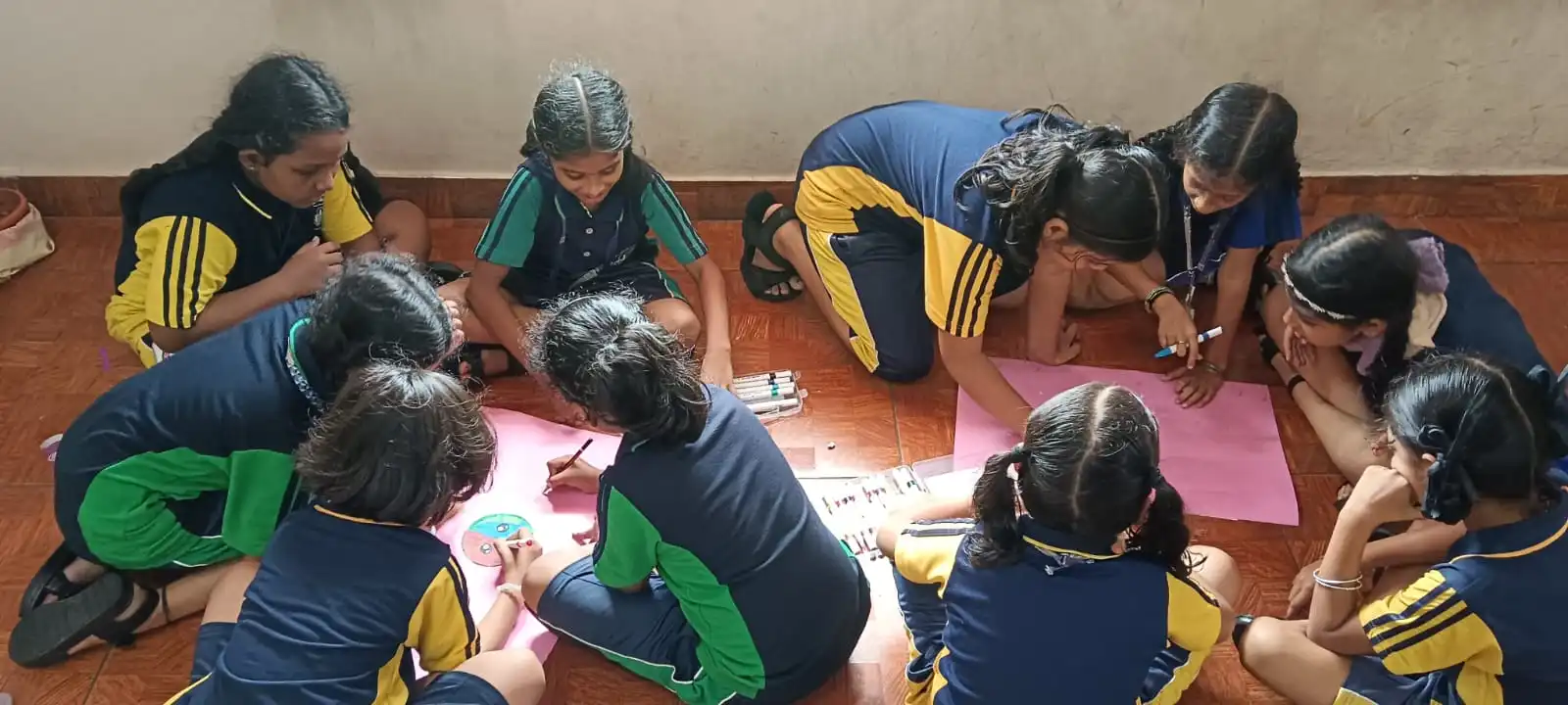Vidyodaya Public School kids holding up posters and eco-friendly crafts during Vanamahotsav