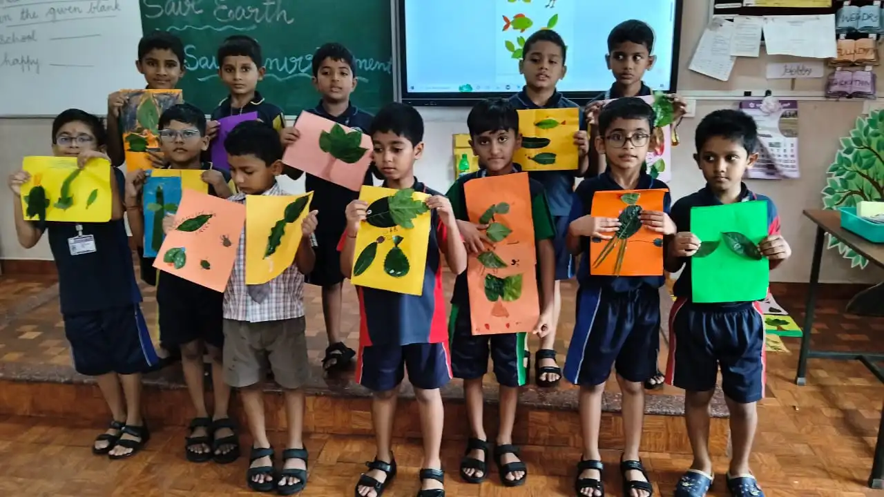 Vidyodaya Public School kids holding up posters and eco-friendly crafts during Vanamahotsav