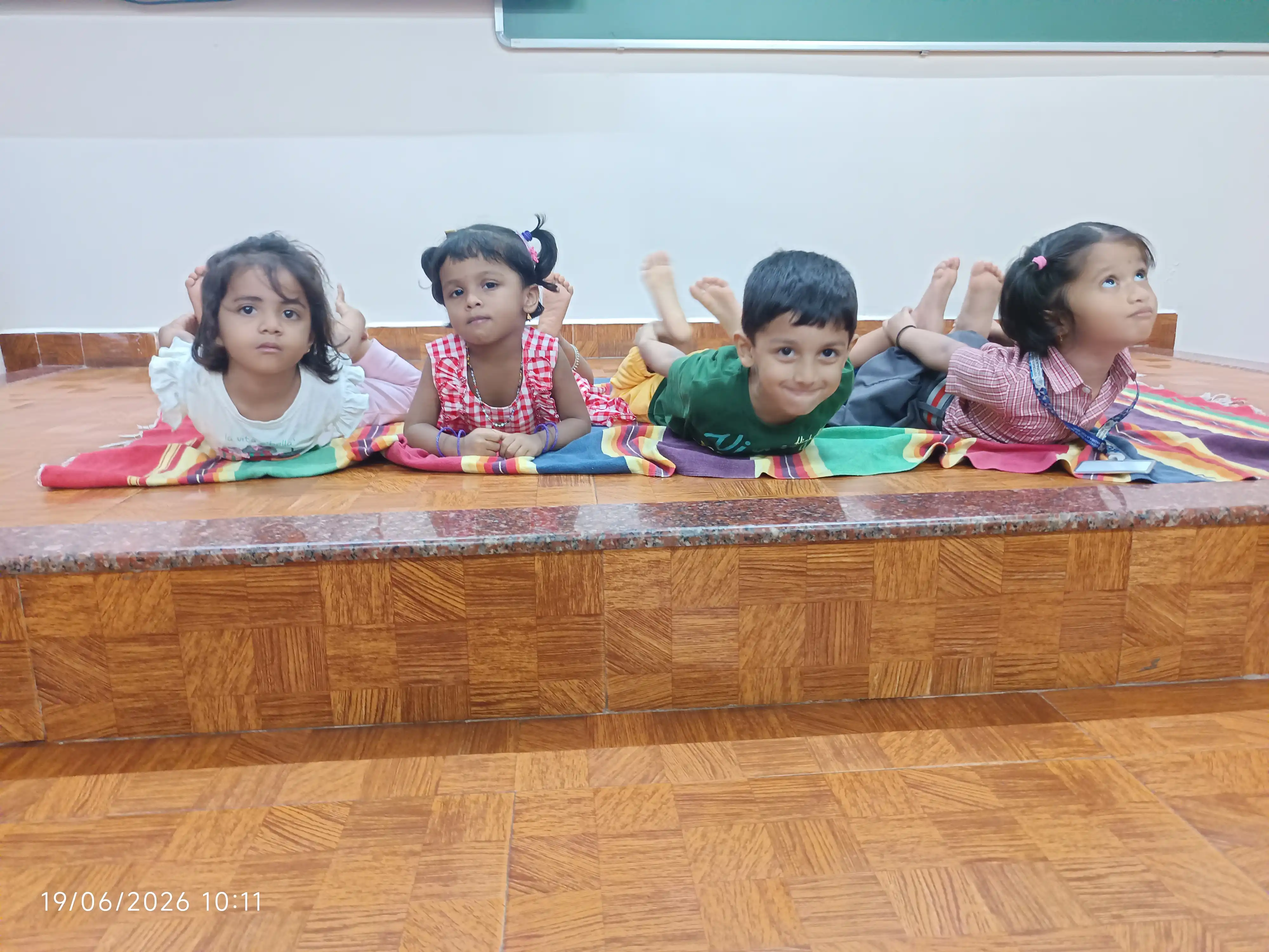 Children practicing yoga postures at Vidyodaya Public School