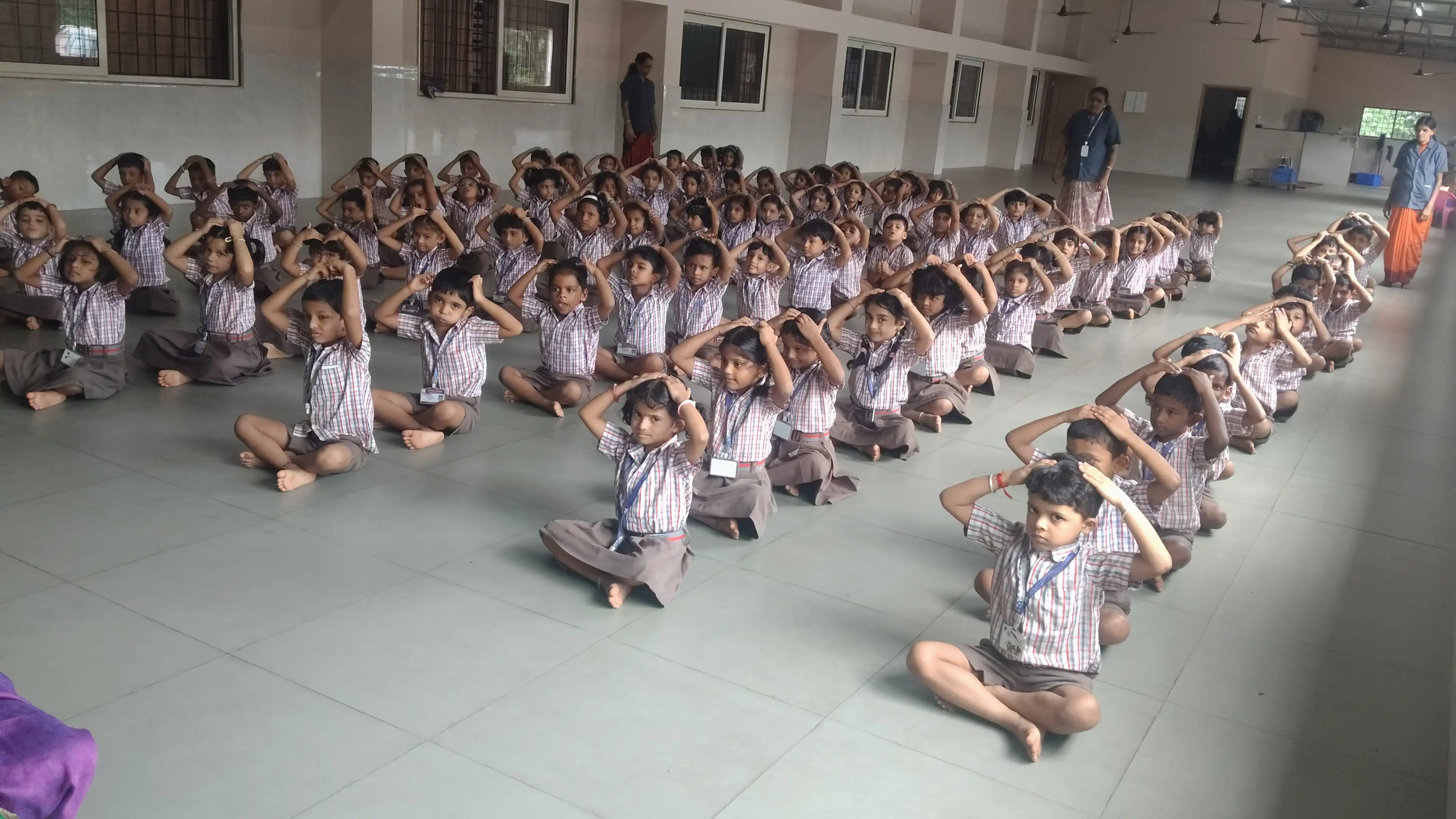 Children practicing yoga postures at Vidyodaya Public School