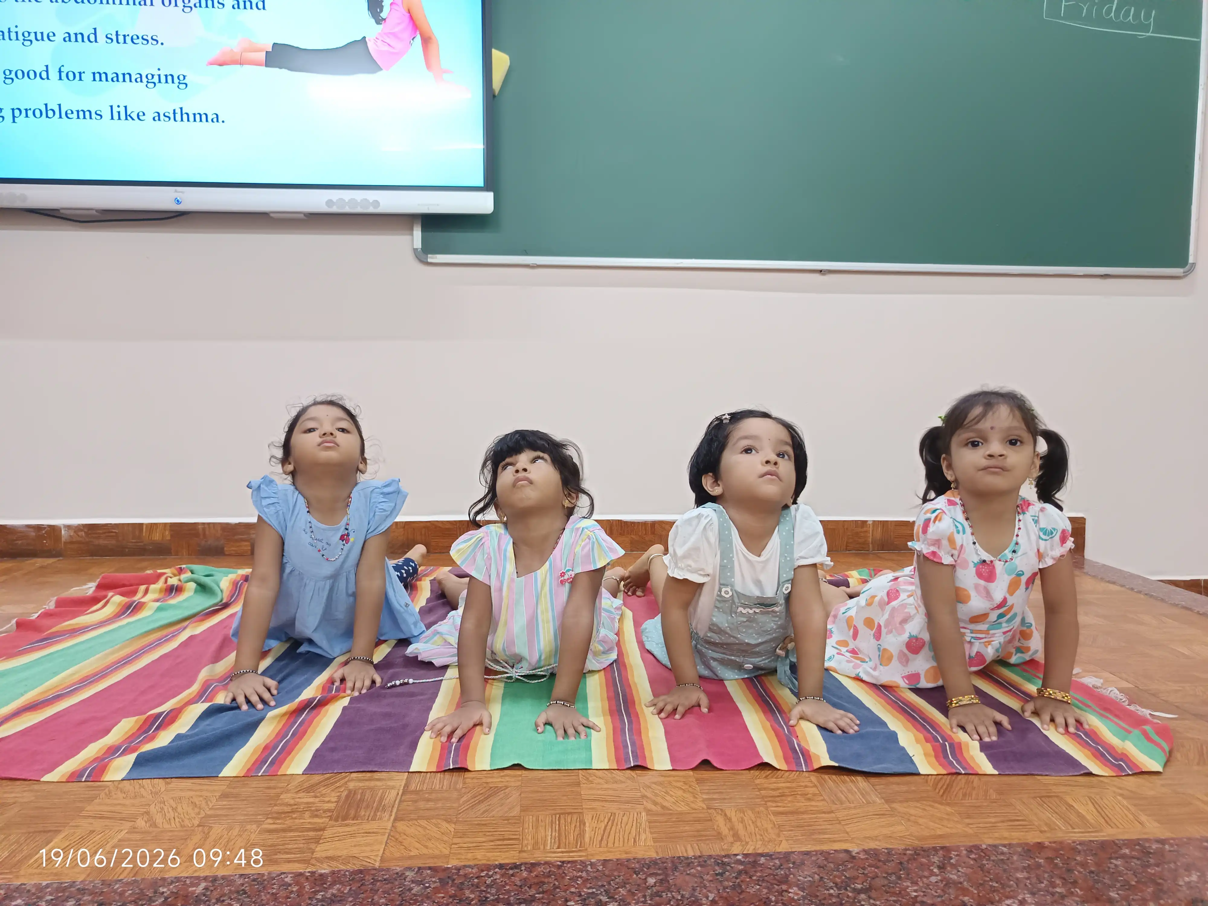 Children practicing yoga postures at Vidyodaya Public School