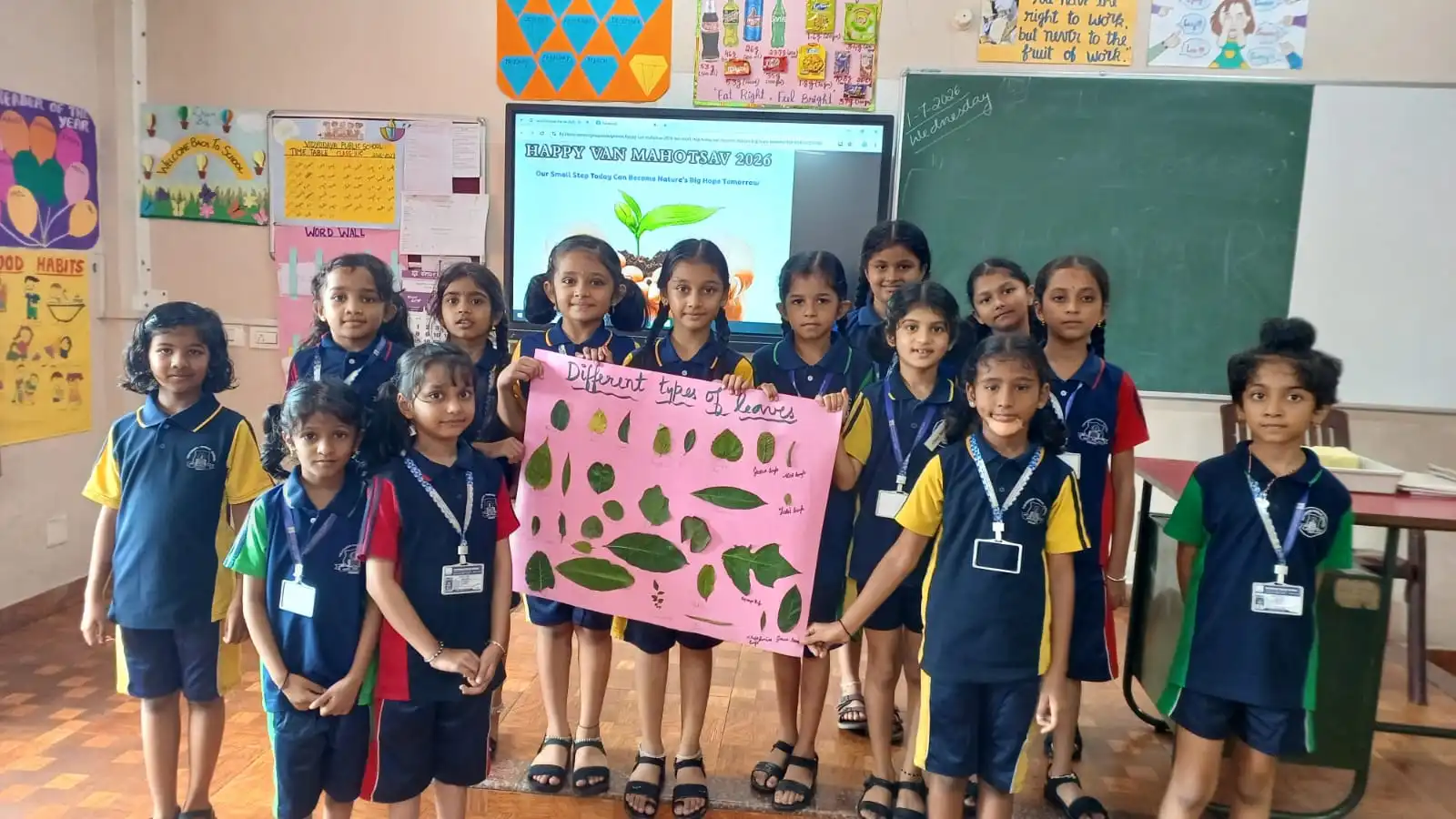 Vidyodaya Public School kids holding up posters and eco-friendly crafts during Vanamahotsav