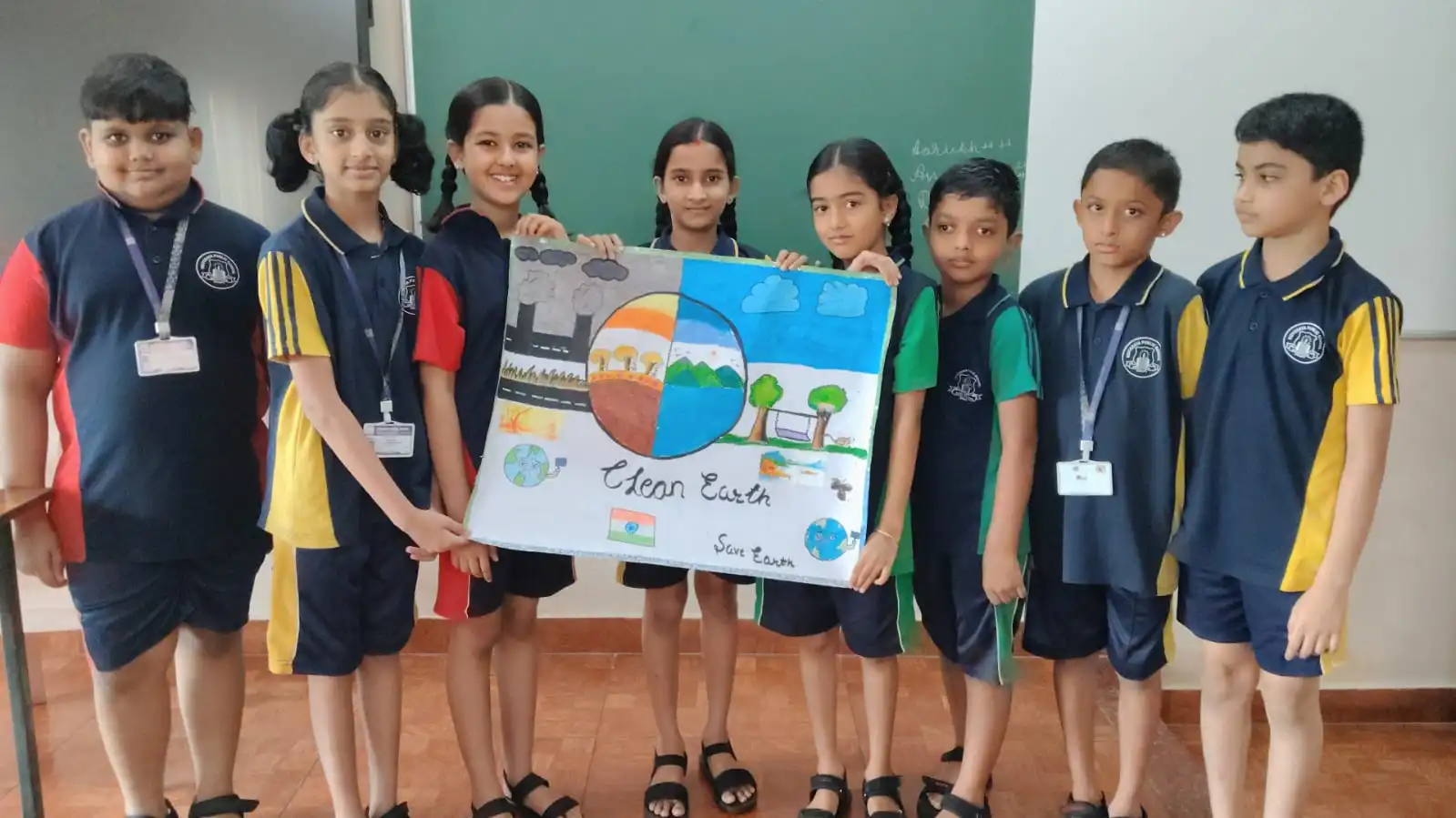 Vidyodaya Public School kids holding up posters and eco-friendly crafts during Vanamahotsav