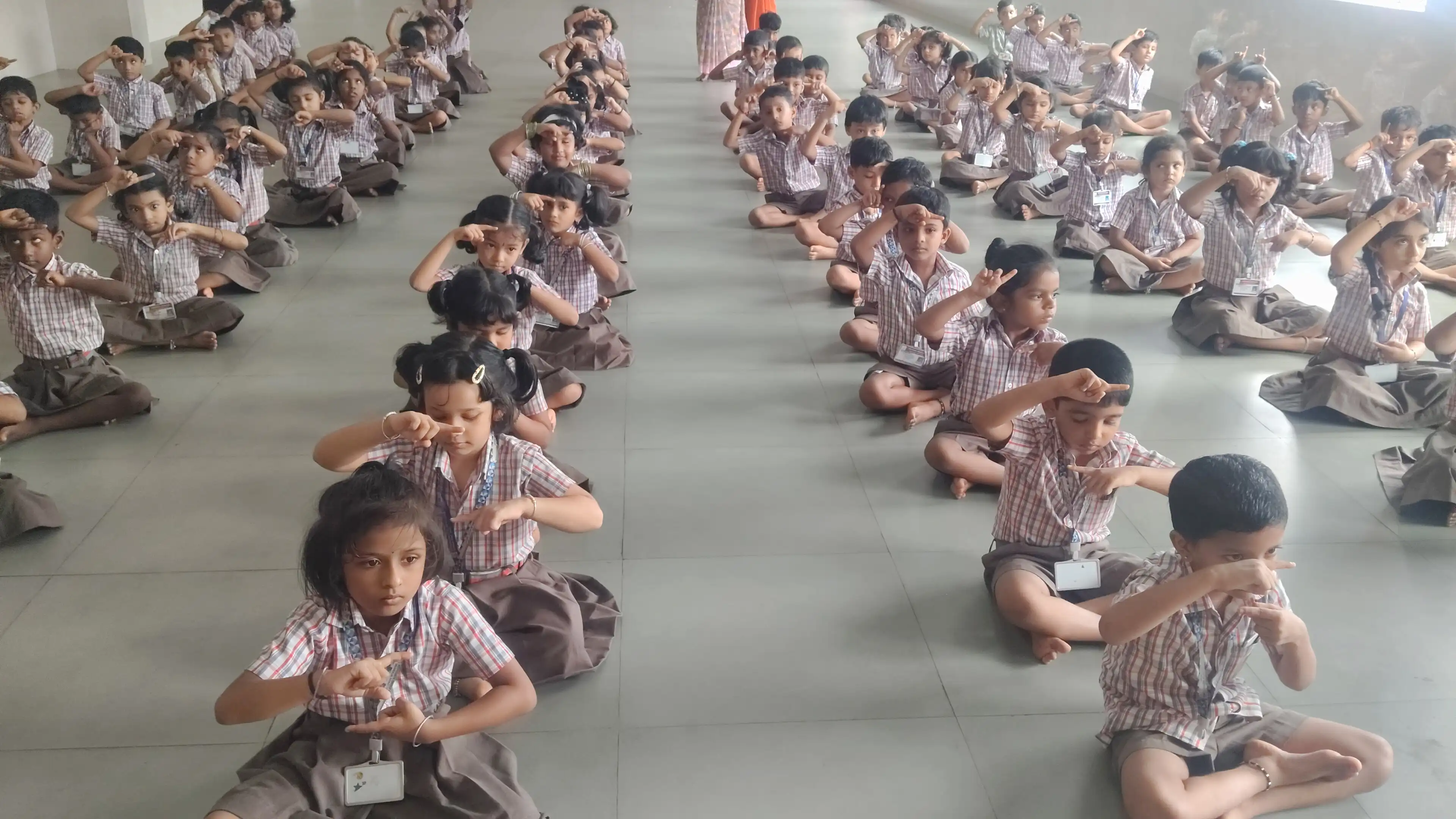 Children practicing yoga postures at Vidyodaya Public School