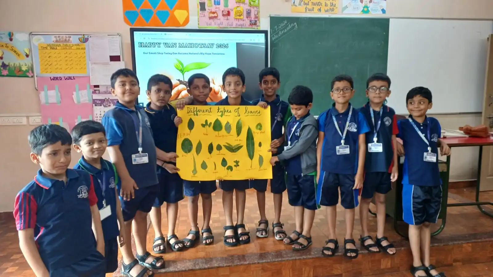 Vidyodaya Public School kids holding up posters and eco-friendly crafts during Vanamahotsav