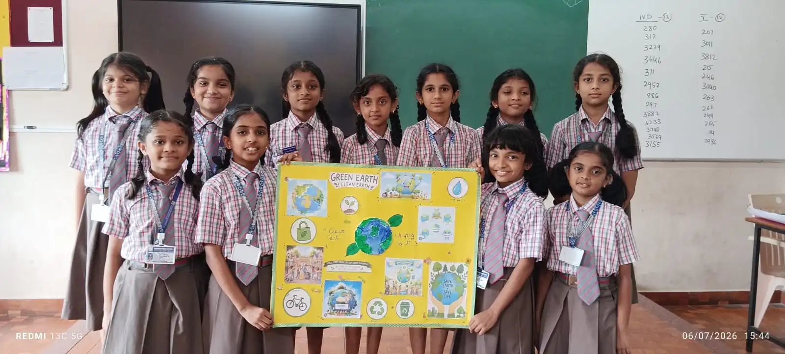 Vidyodaya Public School kids holding up posters and eco-friendly crafts during Vanamahotsav