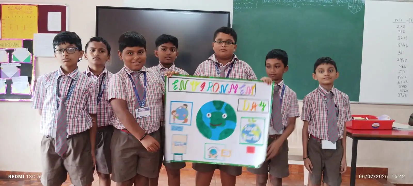 Vidyodaya Public School kids holding up posters and eco-friendly crafts during Vanamahotsav