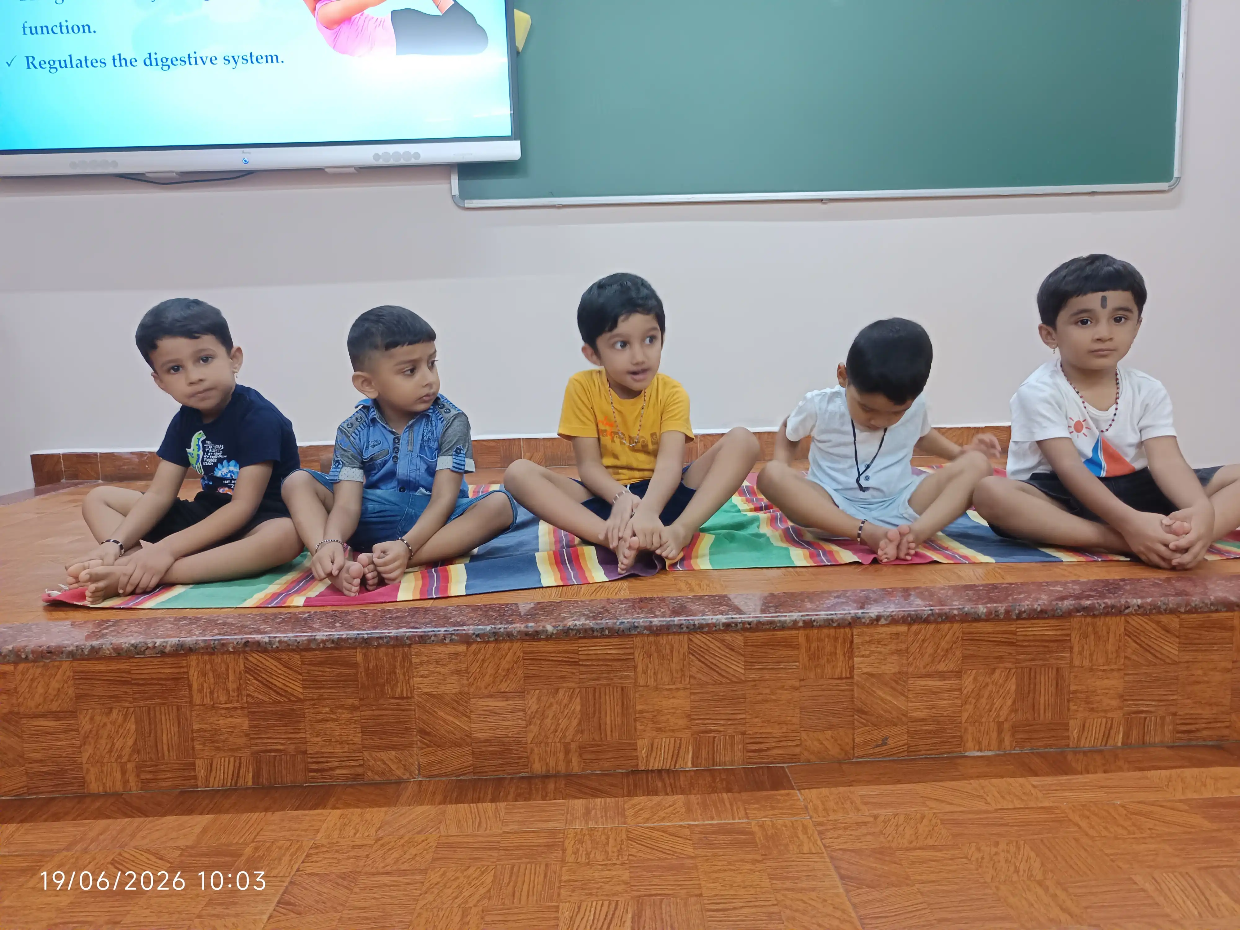Children practicing yoga postures at Vidyodaya Public School