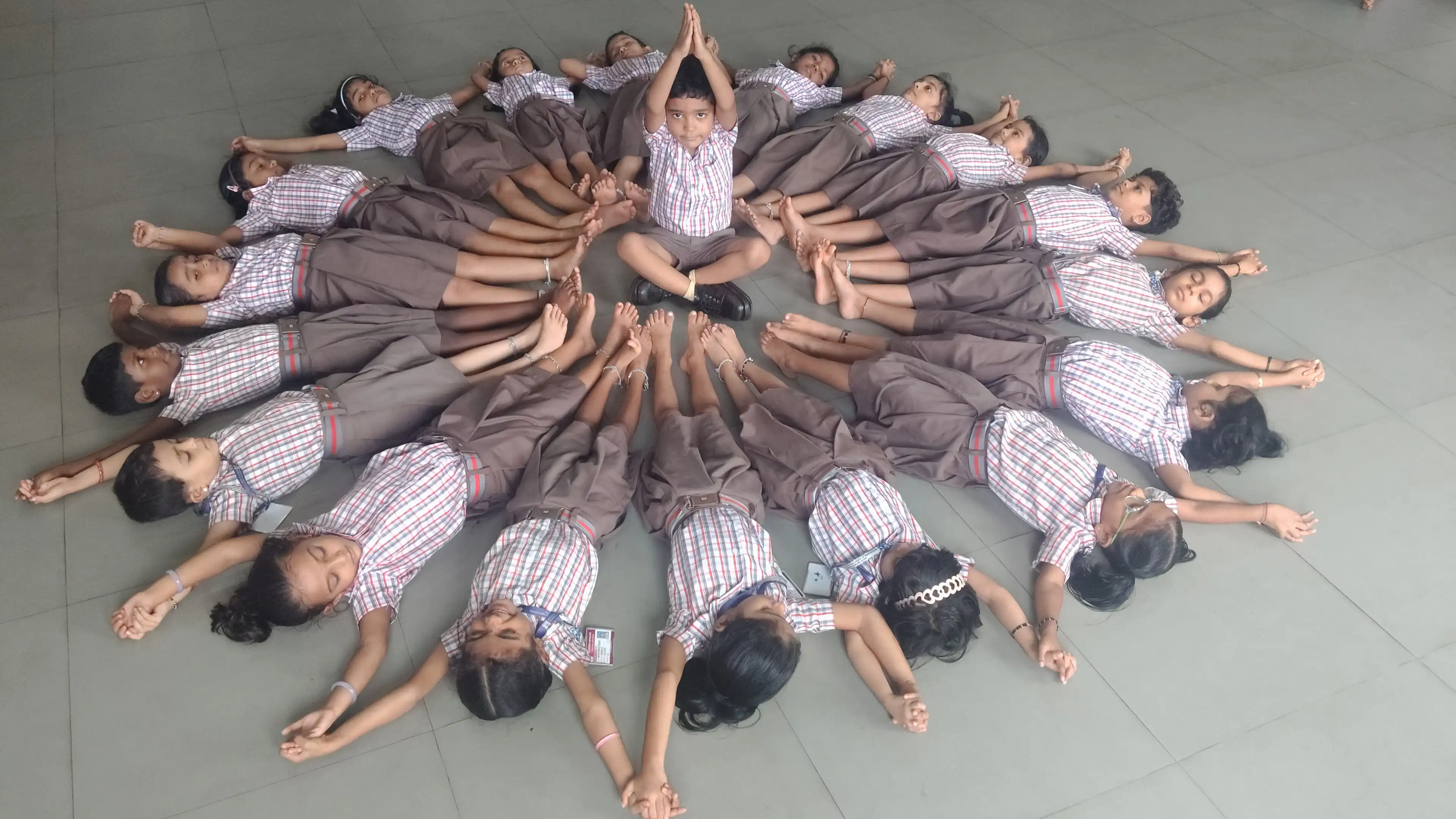 Children practicing yoga postures at Vidyodaya Public School