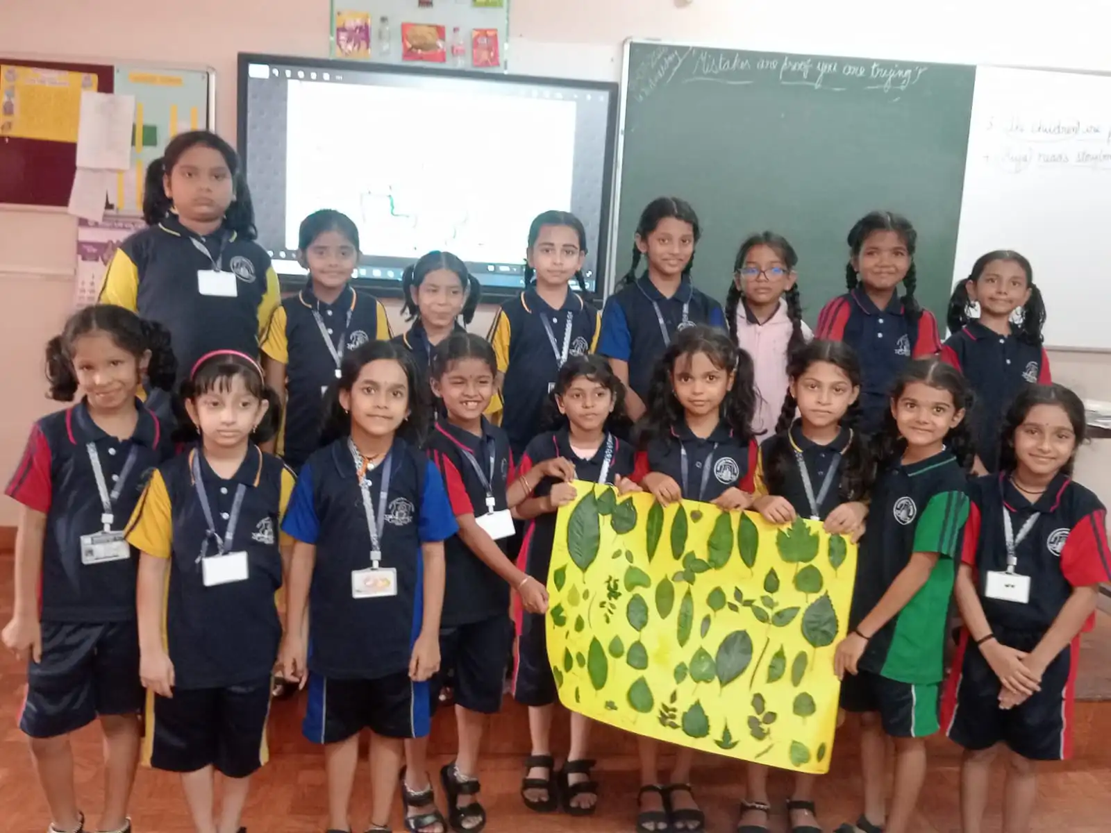 Vidyodaya Public School kids holding up posters and eco-friendly crafts during Vanamahotsav