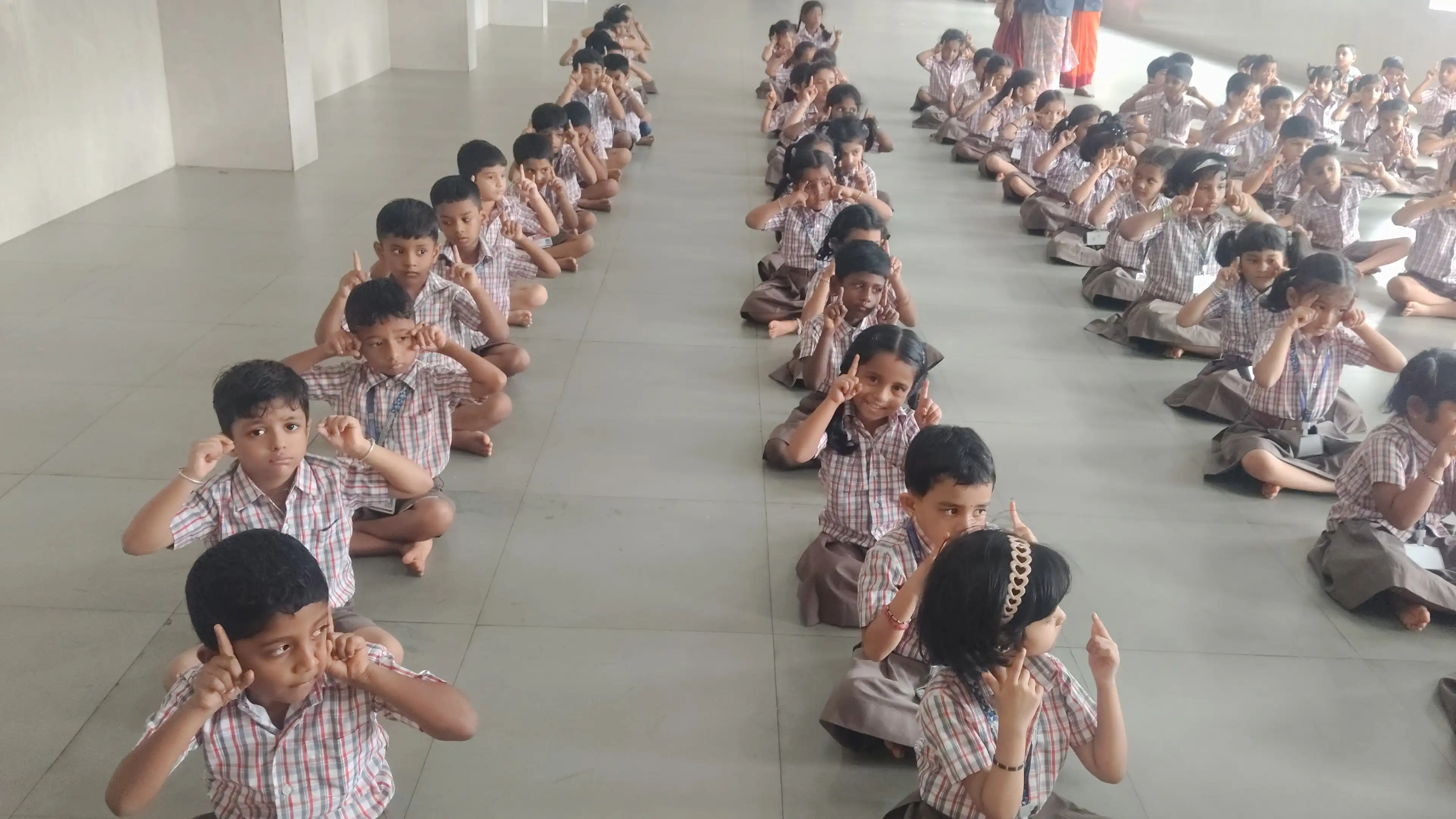 Children practicing yoga postures at Vidyodaya Public School