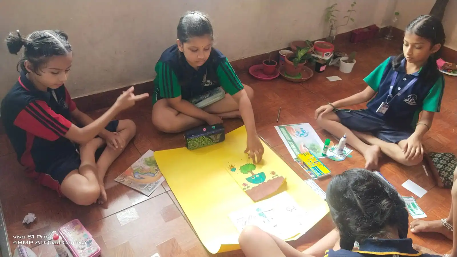 Vidyodaya Public School kids holding up posters and eco-friendly crafts during Vanamahotsav