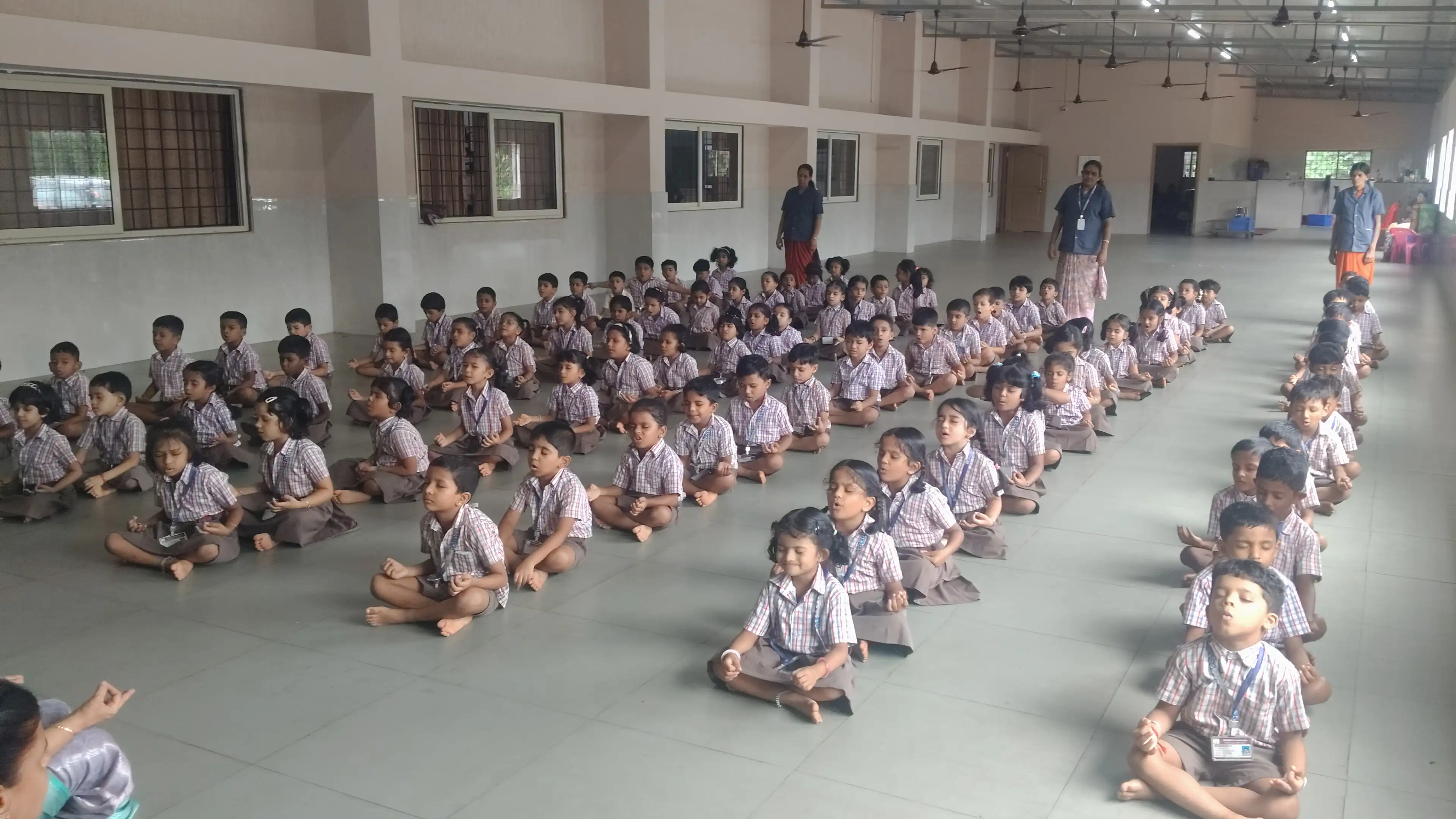 Children practicing yoga postures at Vidyodaya Public School