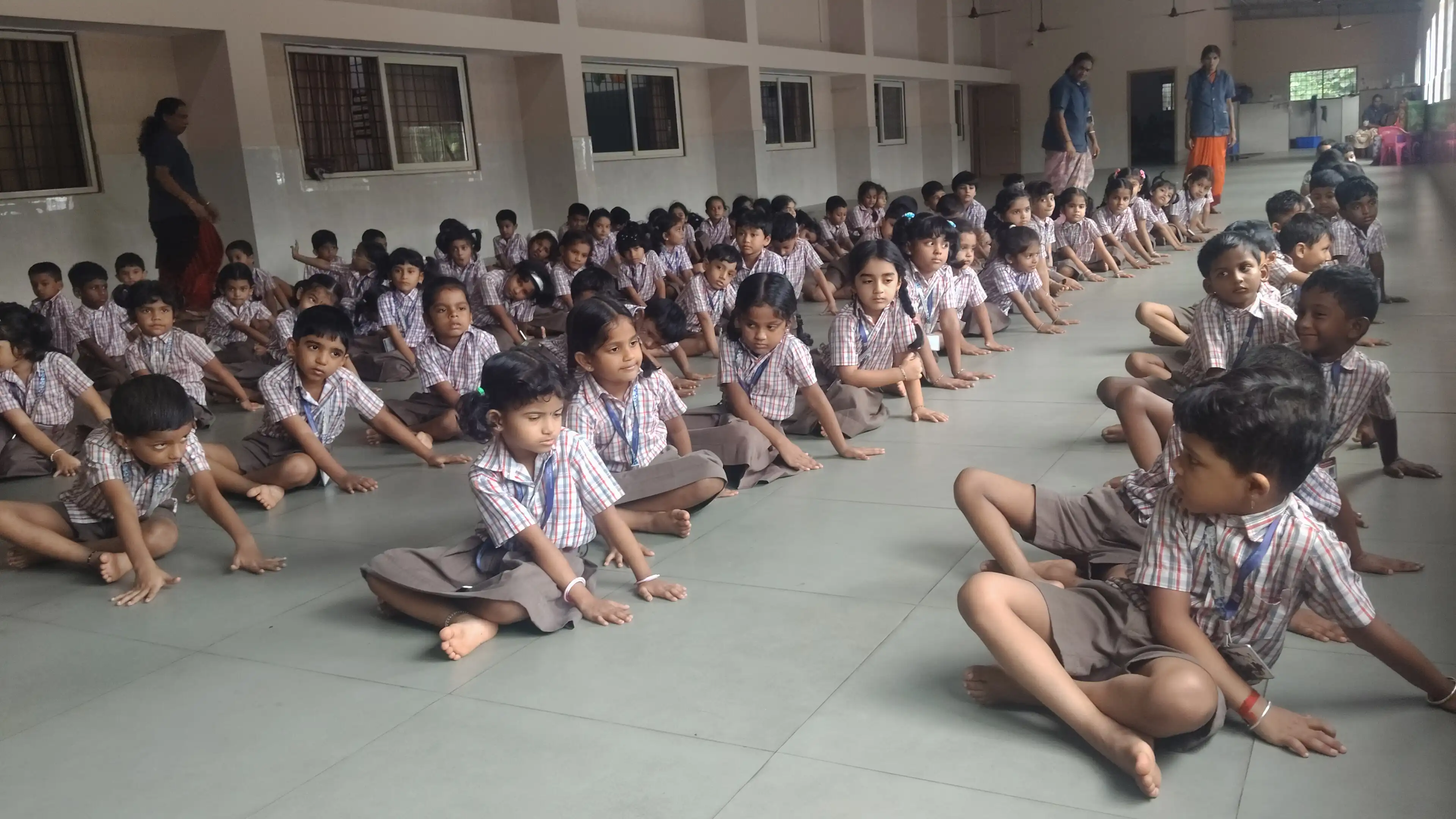 Children practicing yoga postures at Vidyodaya Public School