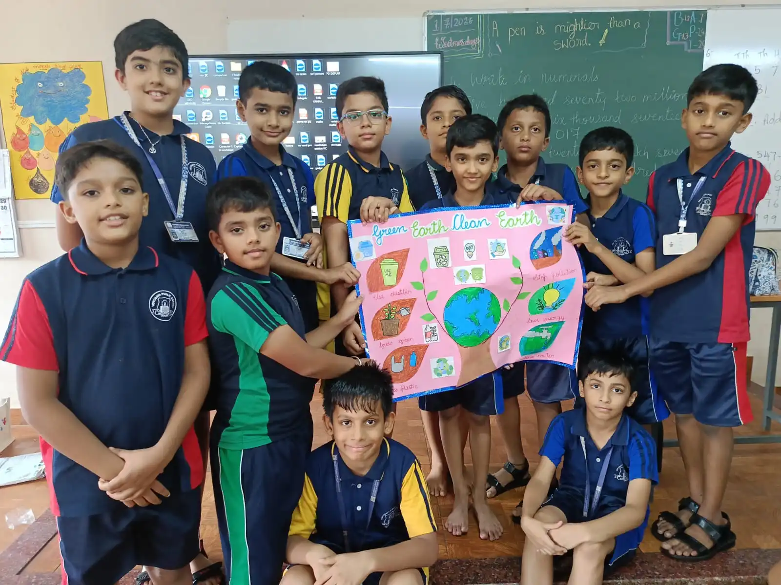 Vidyodaya Public School kids holding up posters and eco-friendly crafts during Vanamahotsav