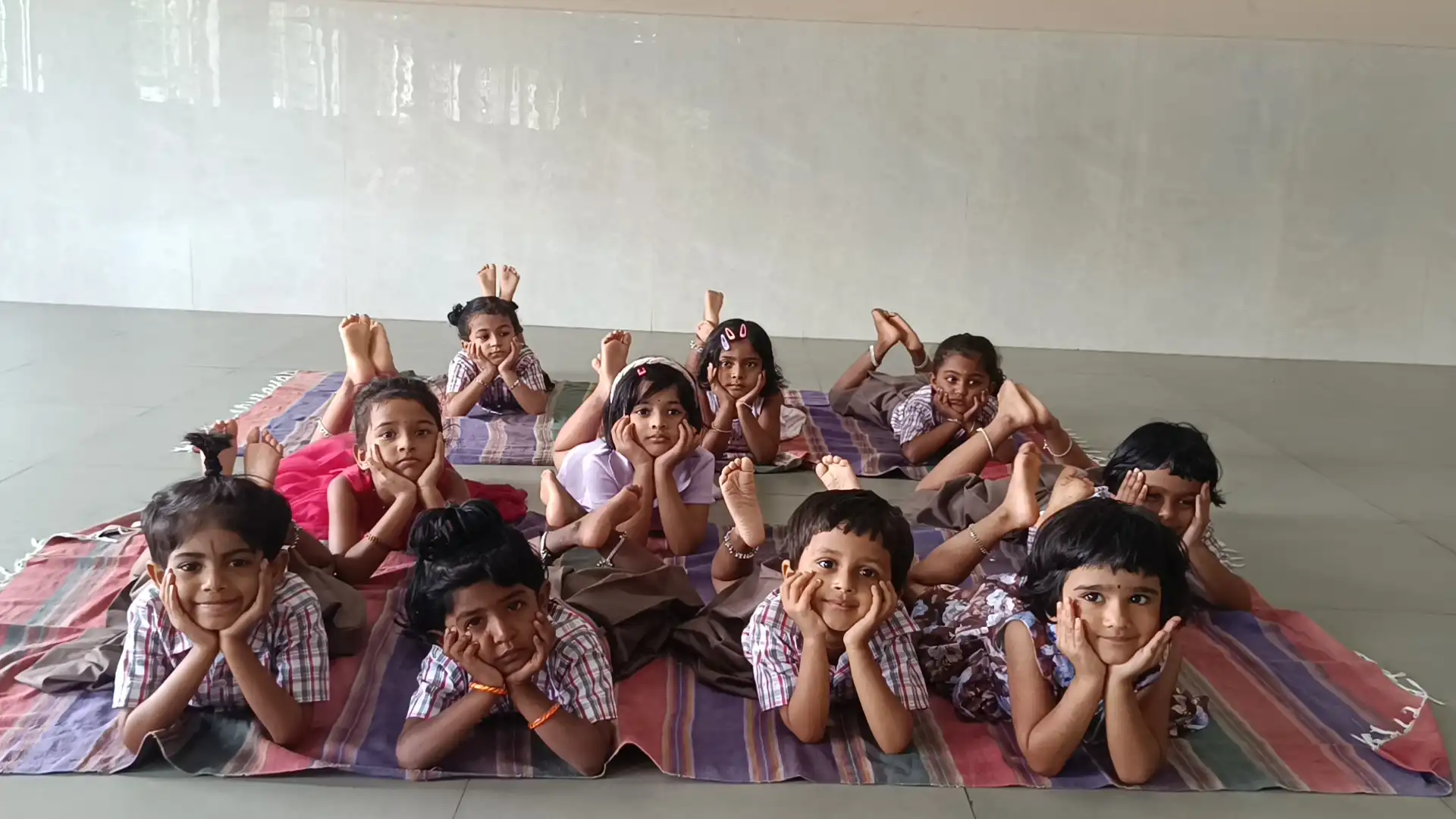 Children practicing yoga postures at Vidyodaya Public School