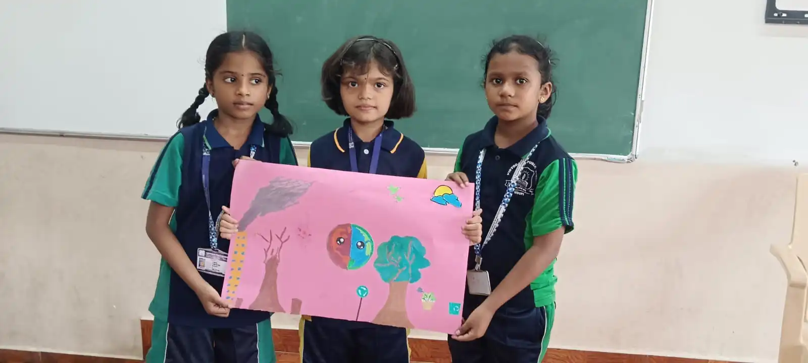 Vidyodaya Public School kids holding up posters and eco-friendly crafts during Vanamahotsav