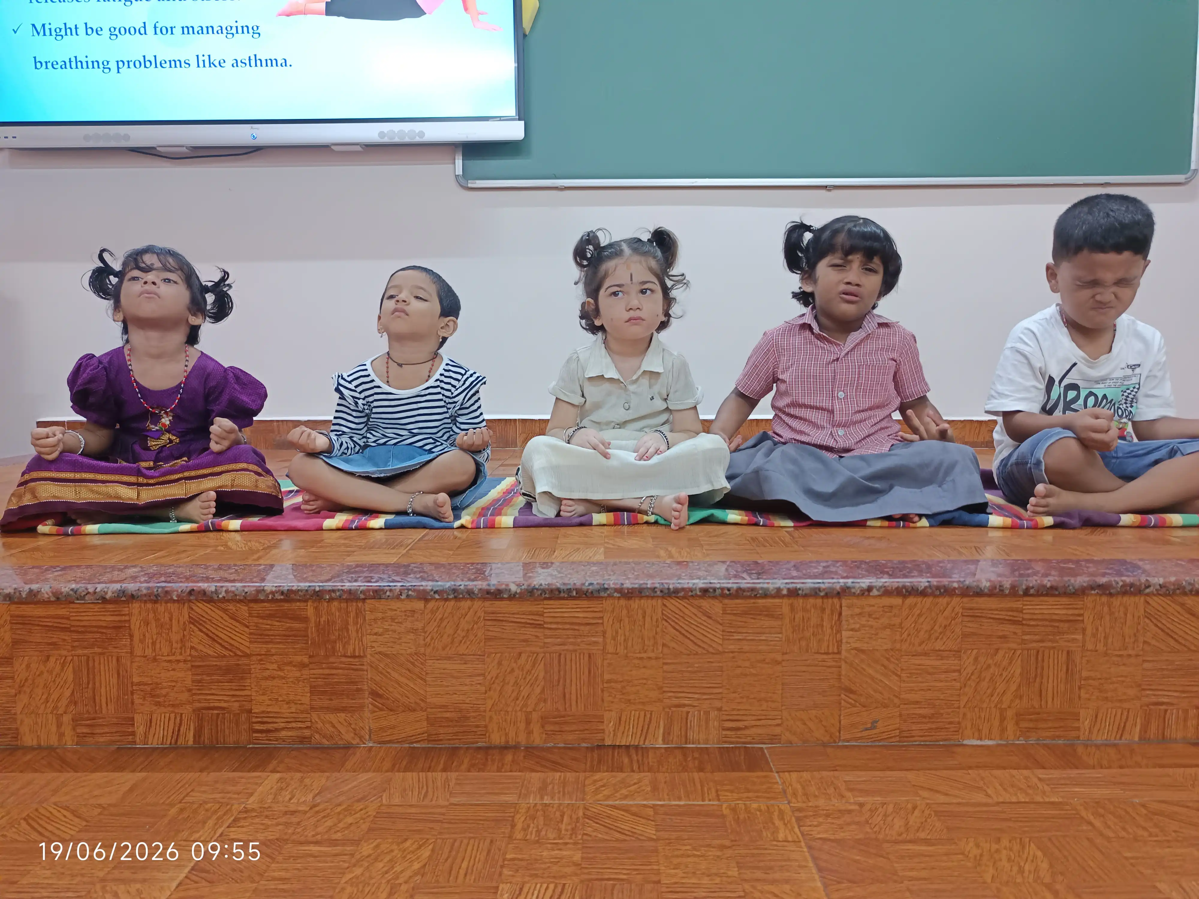 Children practicing yoga postures at Vidyodaya Public School