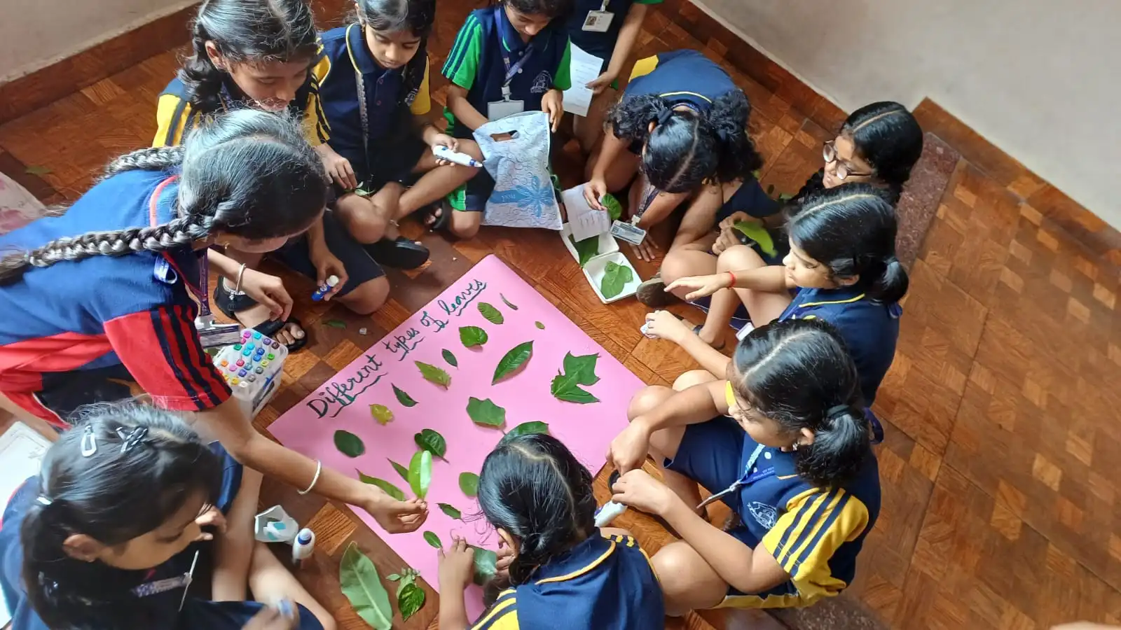 Vidyodaya Public School kids holding up posters and eco-friendly crafts during Vanamahotsav