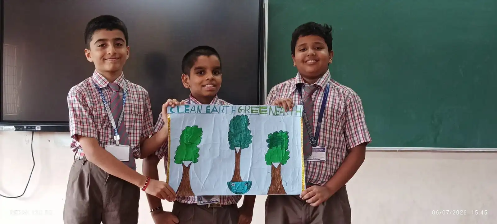 Vidyodaya Public School kids holding up posters and eco-friendly crafts during Vanamahotsav