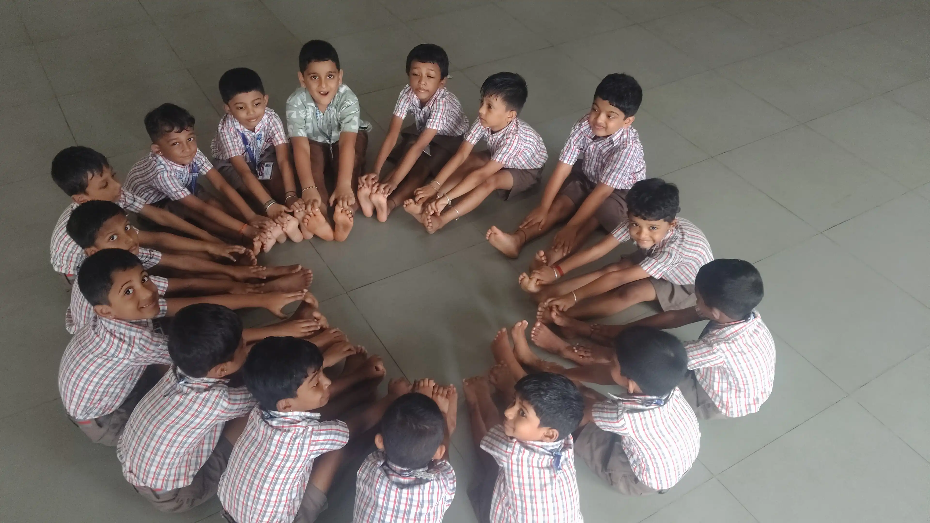 Children practicing yoga postures at Vidyodaya Public School