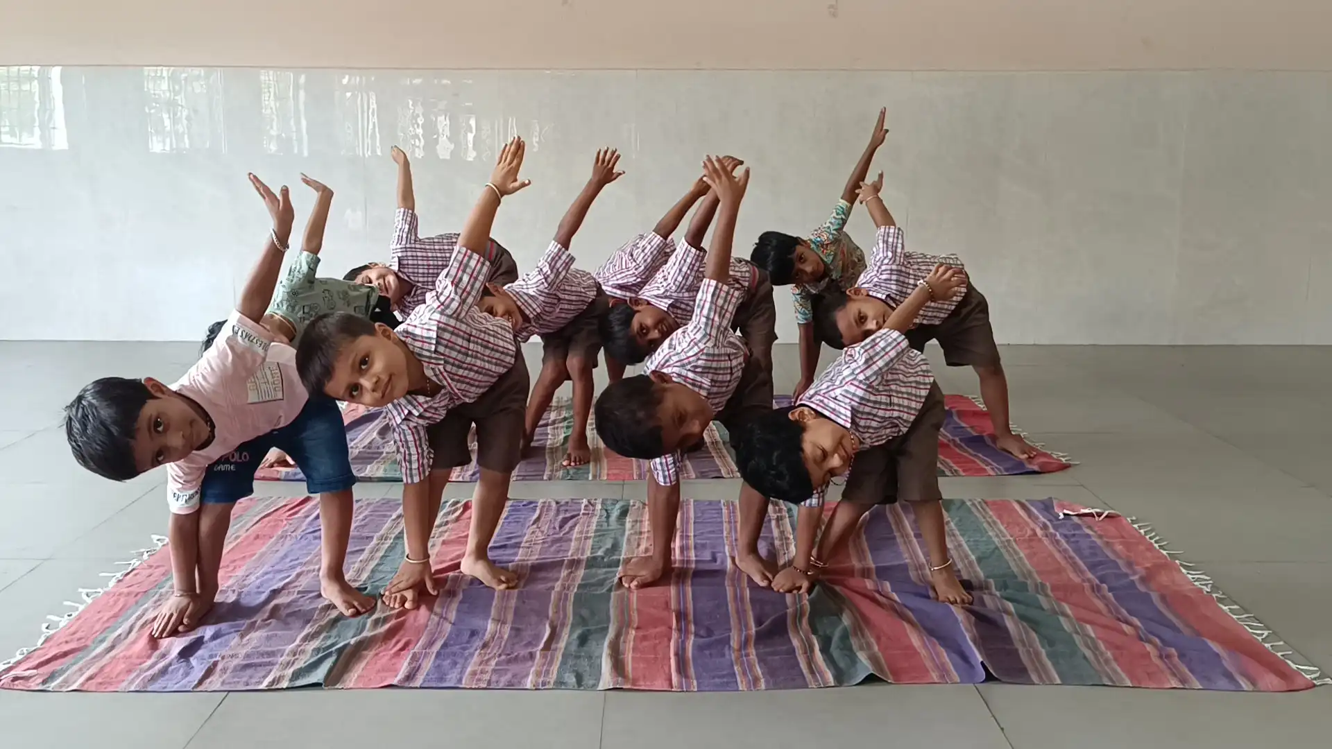 Children practicing yoga postures at Vidyodaya Public School