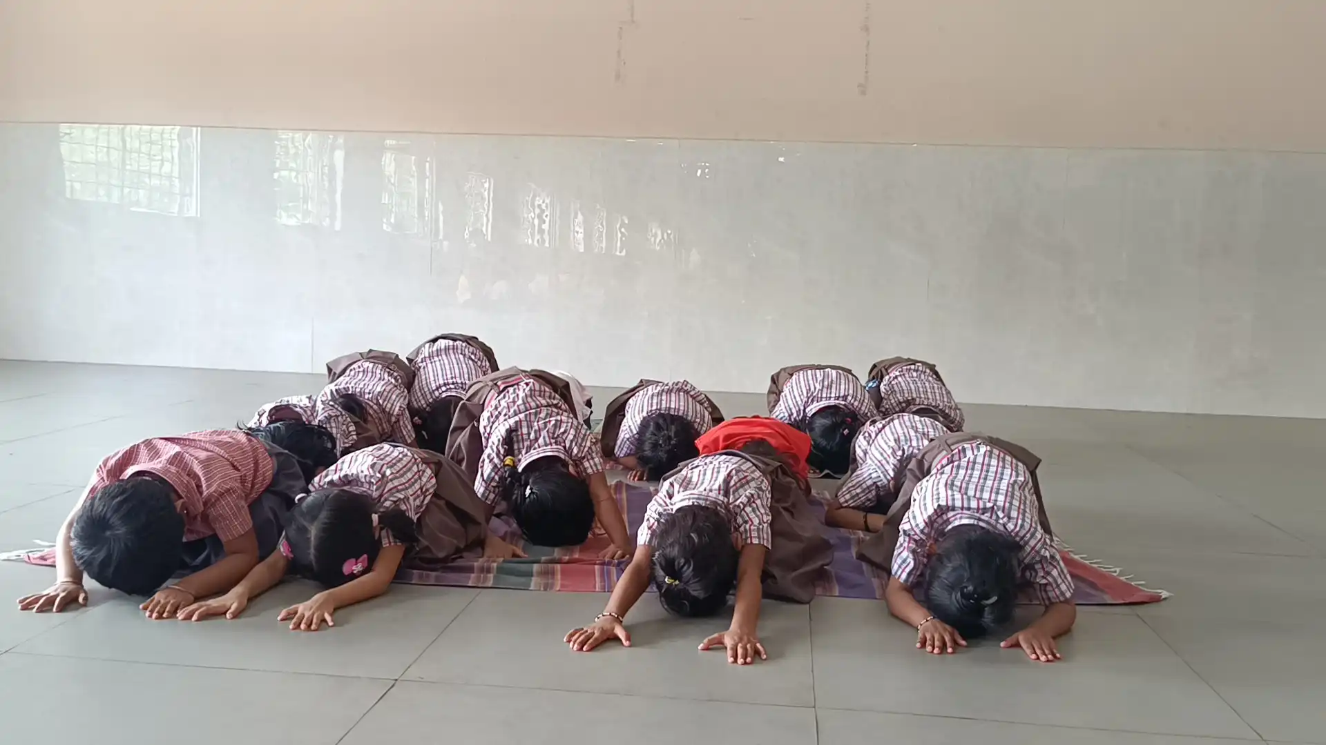 Children practicing yoga postures at Vidyodaya Public School