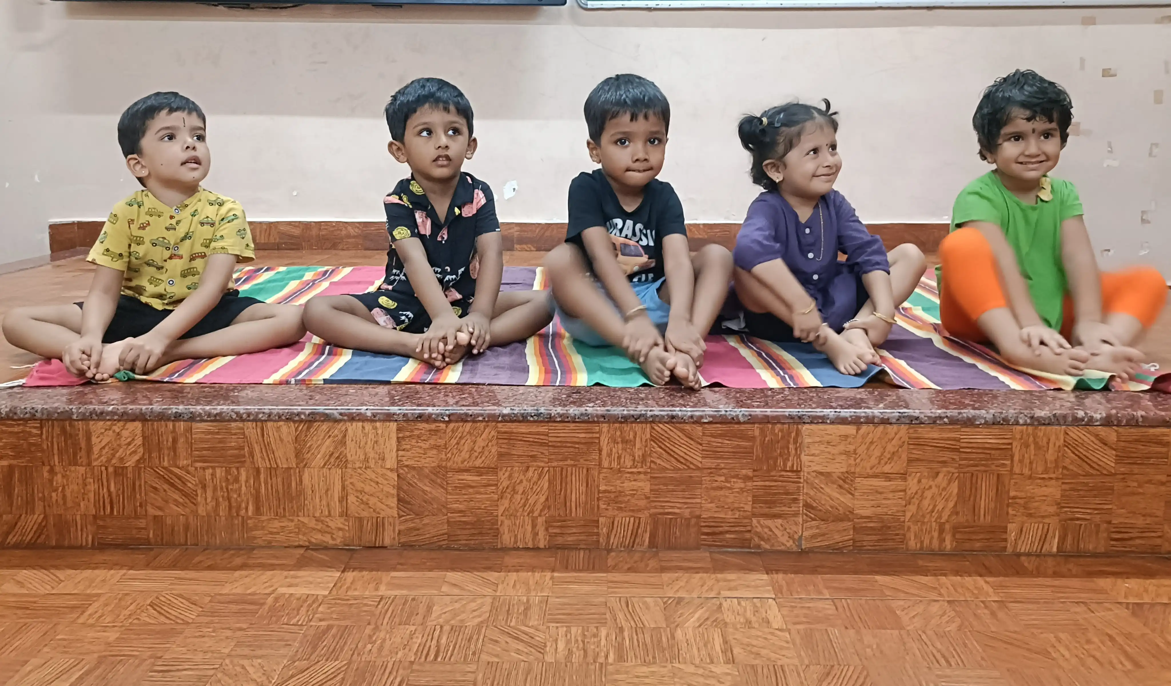 Children practicing yoga postures at Vidyodaya Public School