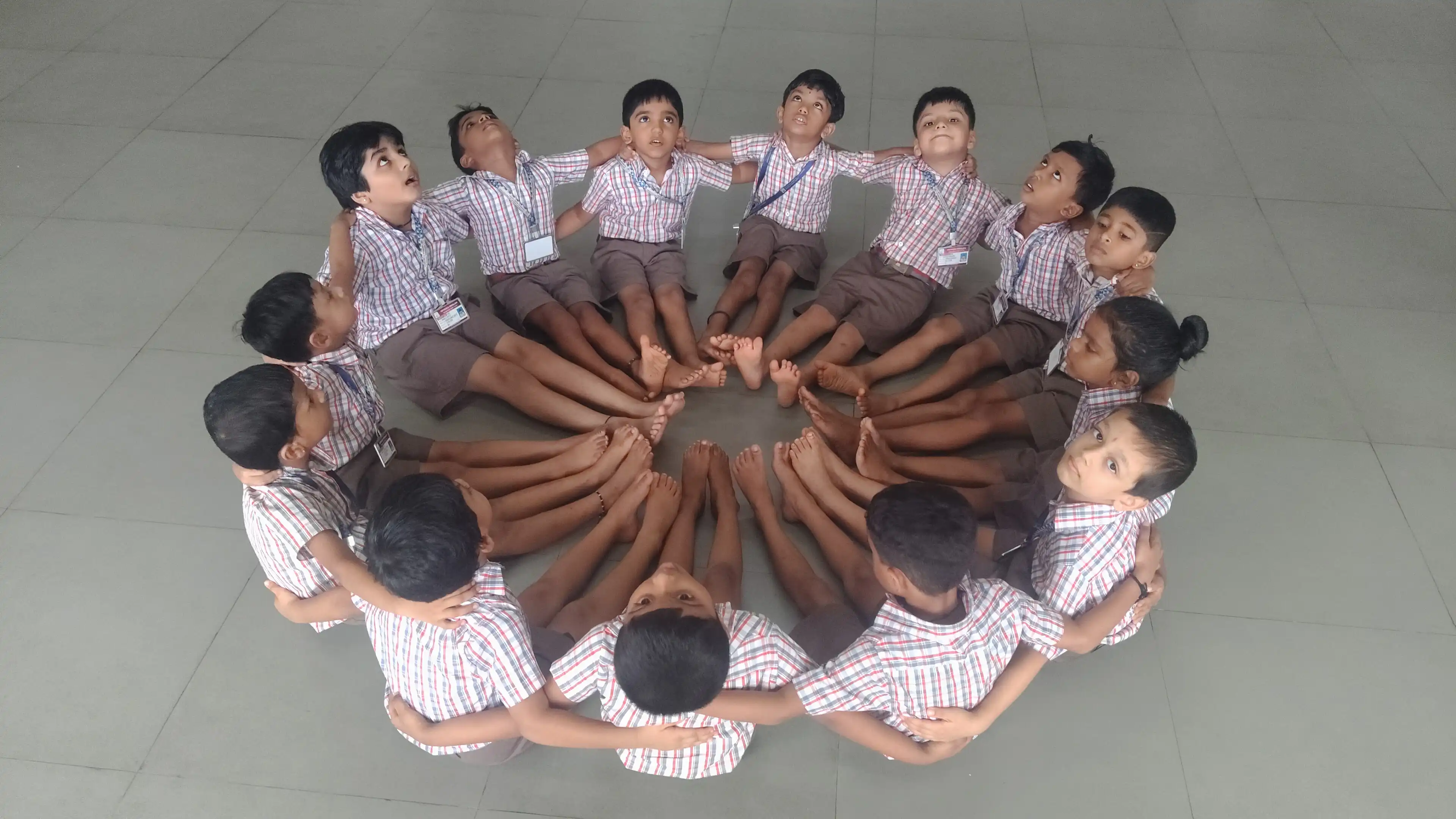 Children practicing yoga postures at Vidyodaya Public School