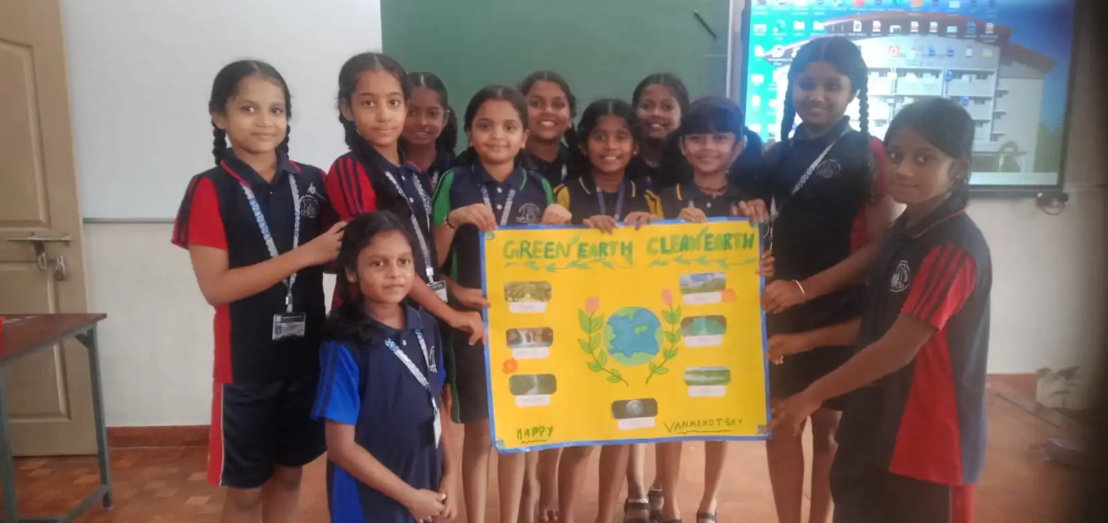Vidyodaya Public School kids holding up posters and eco-friendly crafts during Vanamahotsav