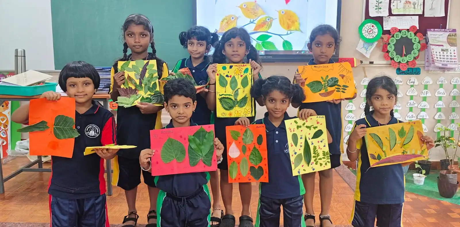Vidyodaya Public School kids holding up posters and eco-friendly crafts during Vanamahotsav