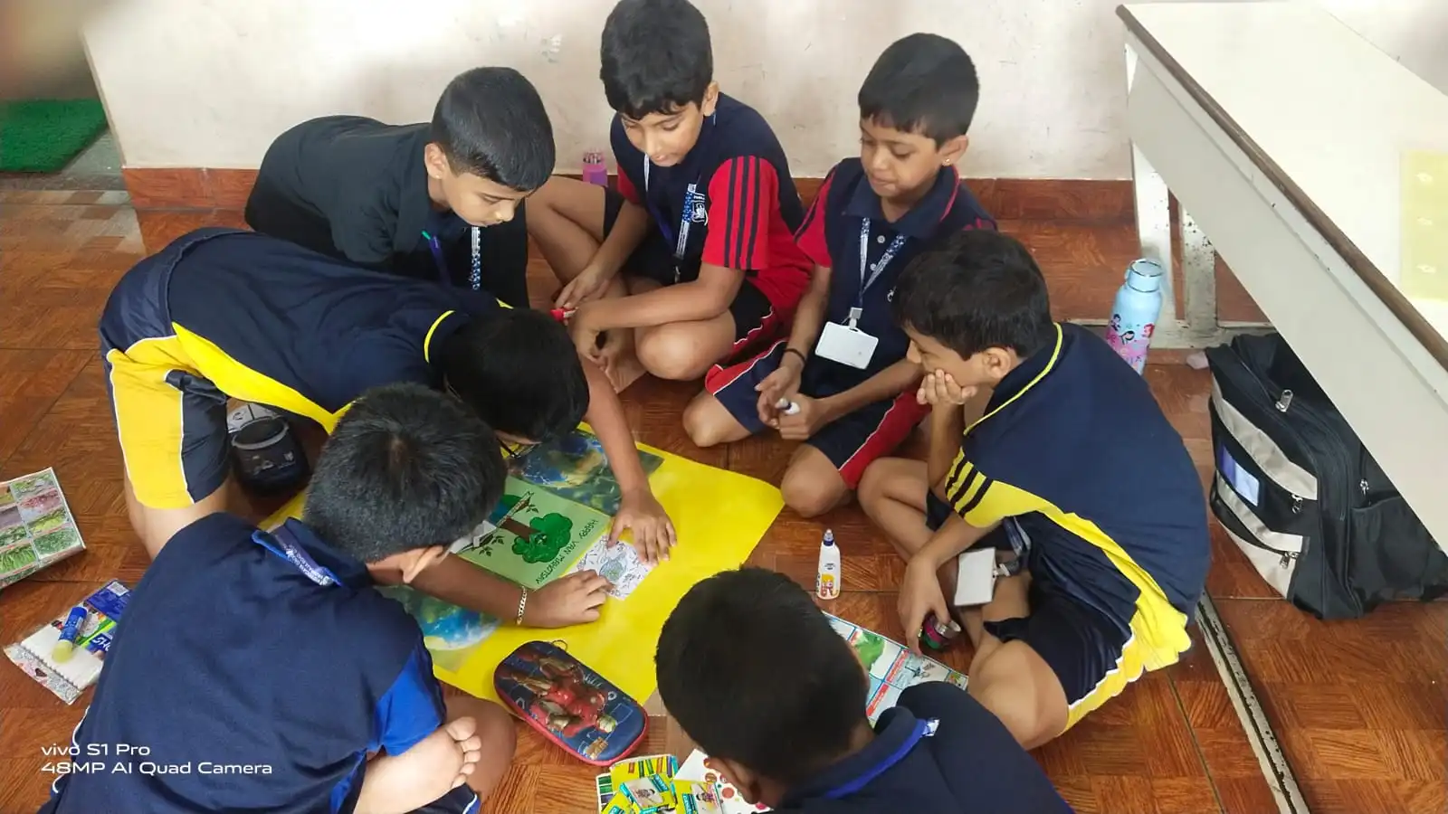 Vidyodaya Public School kids holding up posters and eco-friendly crafts during Vanamahotsav