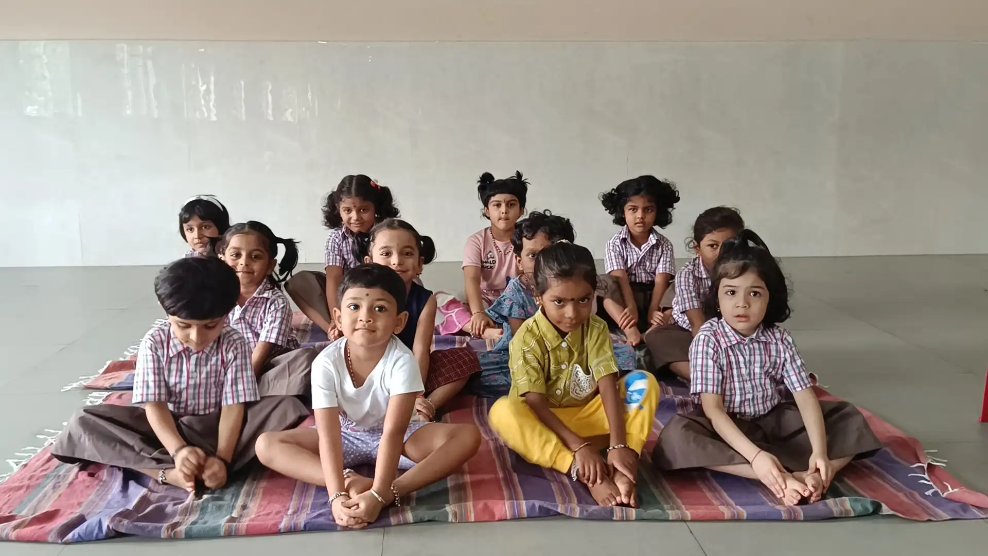 Children practicing yoga postures at Vidyodaya Public School