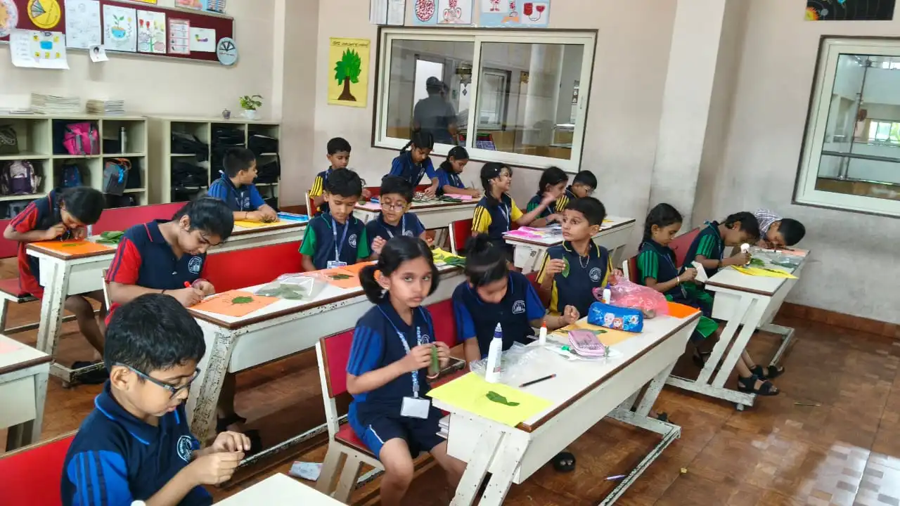 Vidyodaya Public School kids holding up posters and eco-friendly crafts during Vanamahotsav