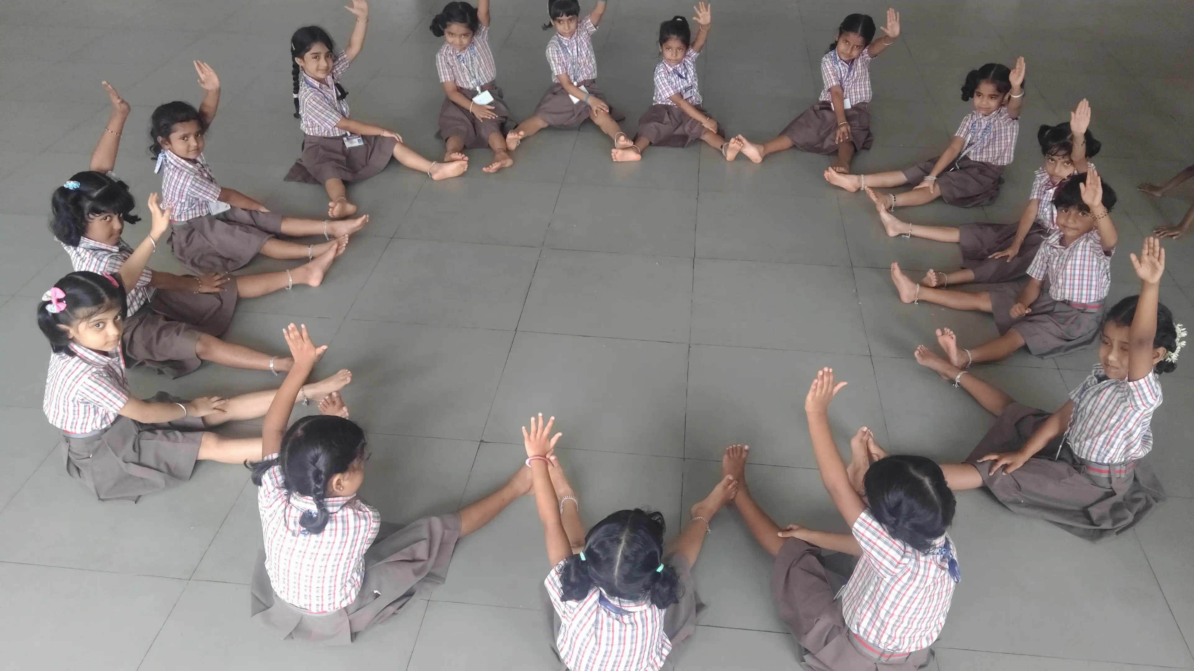 Children practicing yoga postures at Vidyodaya Public School