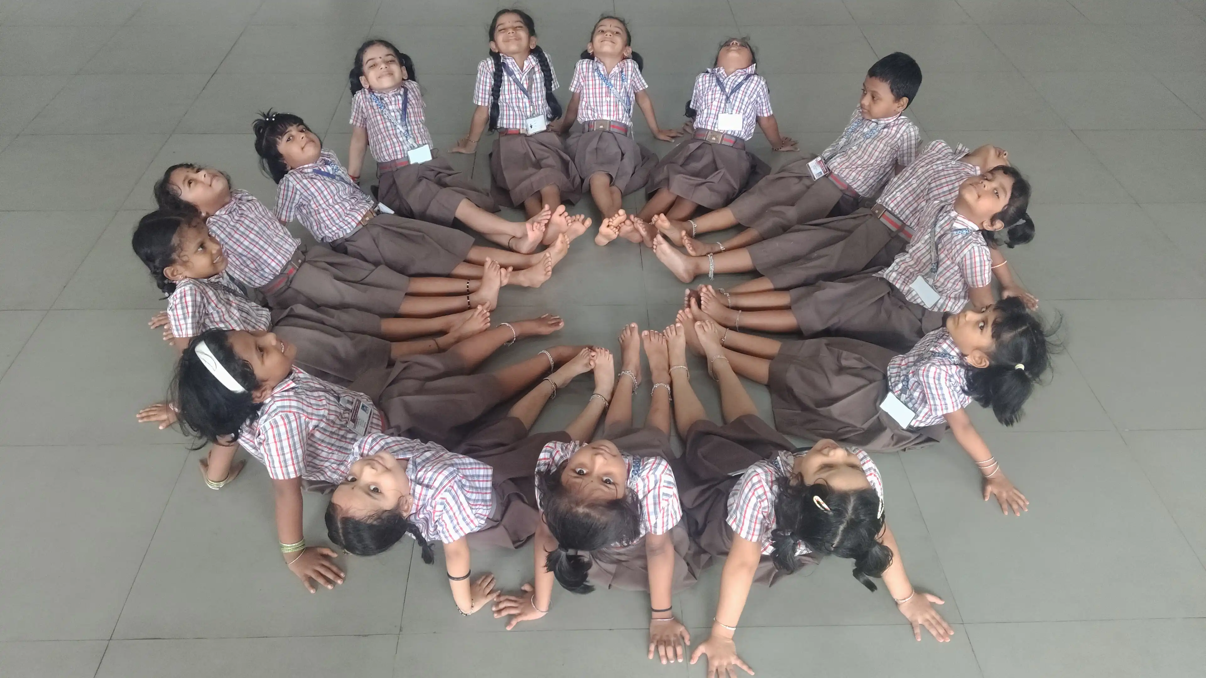 Children practicing yoga postures at Vidyodaya Public School