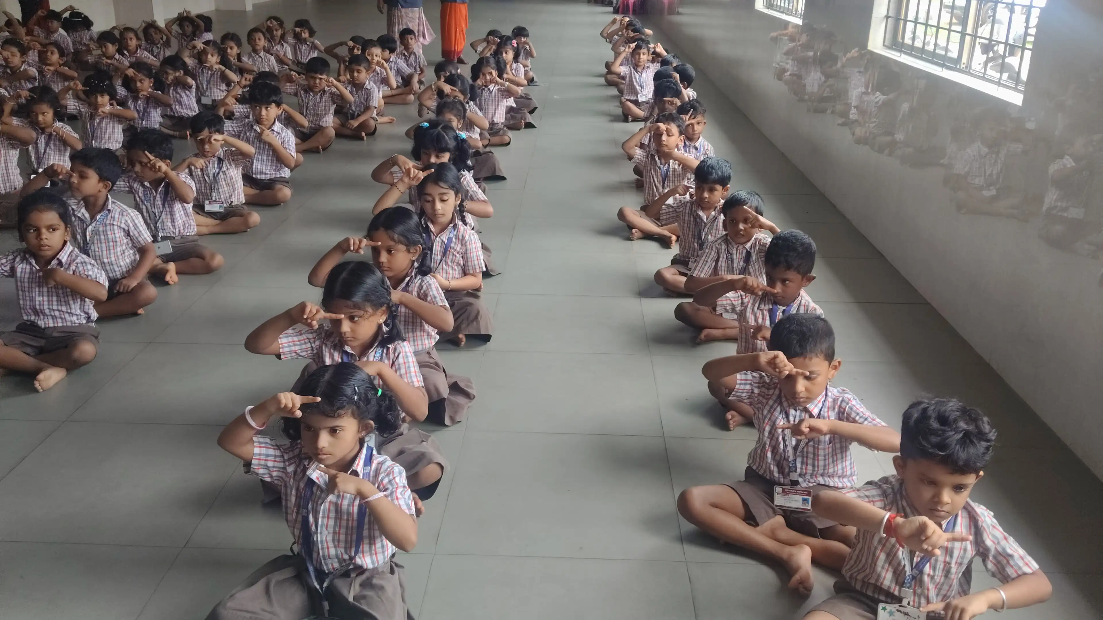 Children practicing yoga postures at Vidyodaya Public School