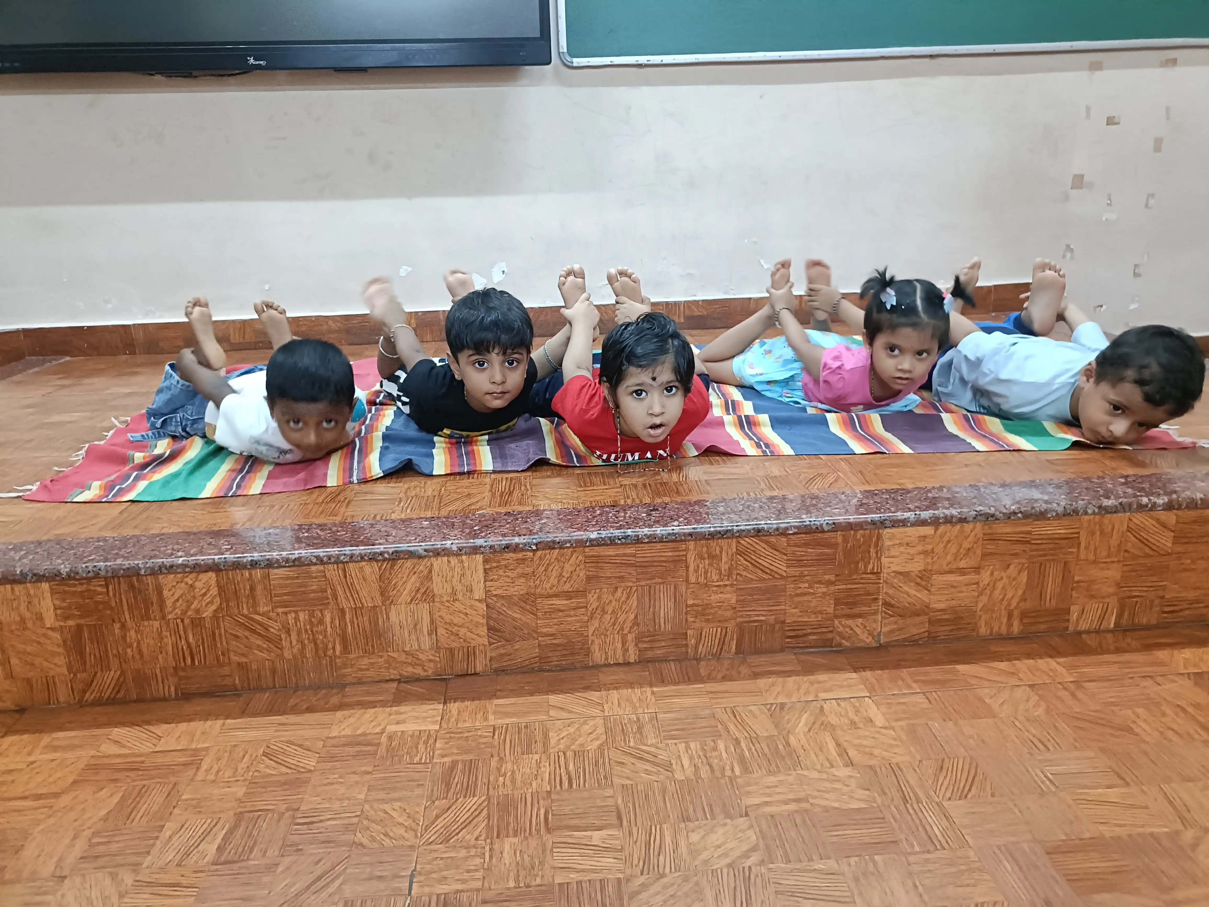Children practicing yoga postures at Vidyodaya Public School