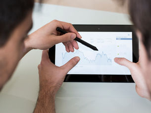 team-discussing-graph-on-tablet