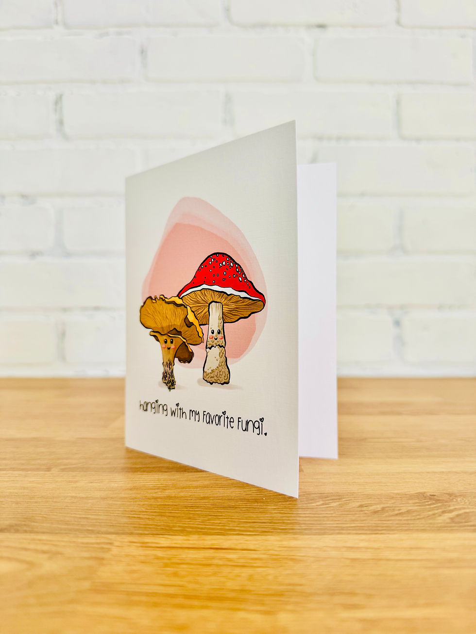 Cute mushroom greeting card with pun “Hanging with My Favorite Fungi,” whimsical red and white mushrooms.