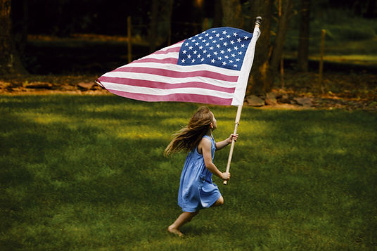 Young Girl Waving American Flag