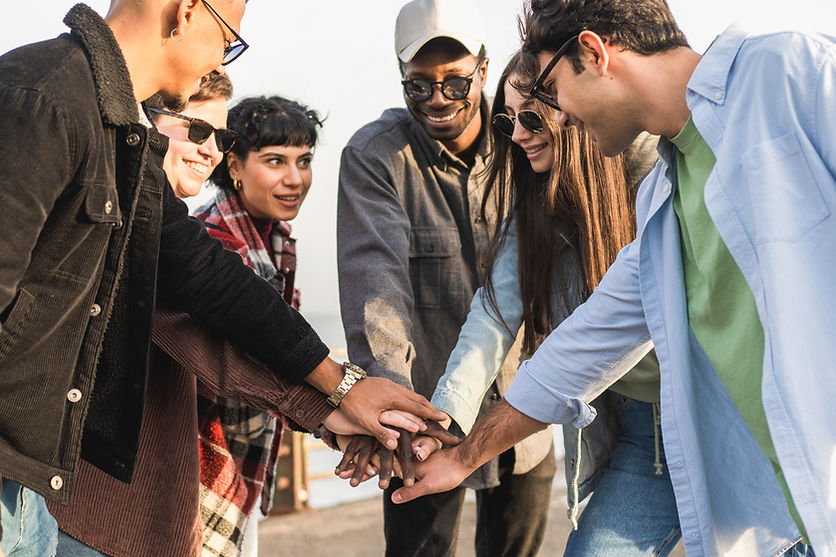 multiracial-friends-united-hands-by-the-seaside-2023-11-27-04-49-20-utc.jpg
