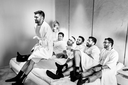 Groom does a trust fall with his groomsmen before the ceremony